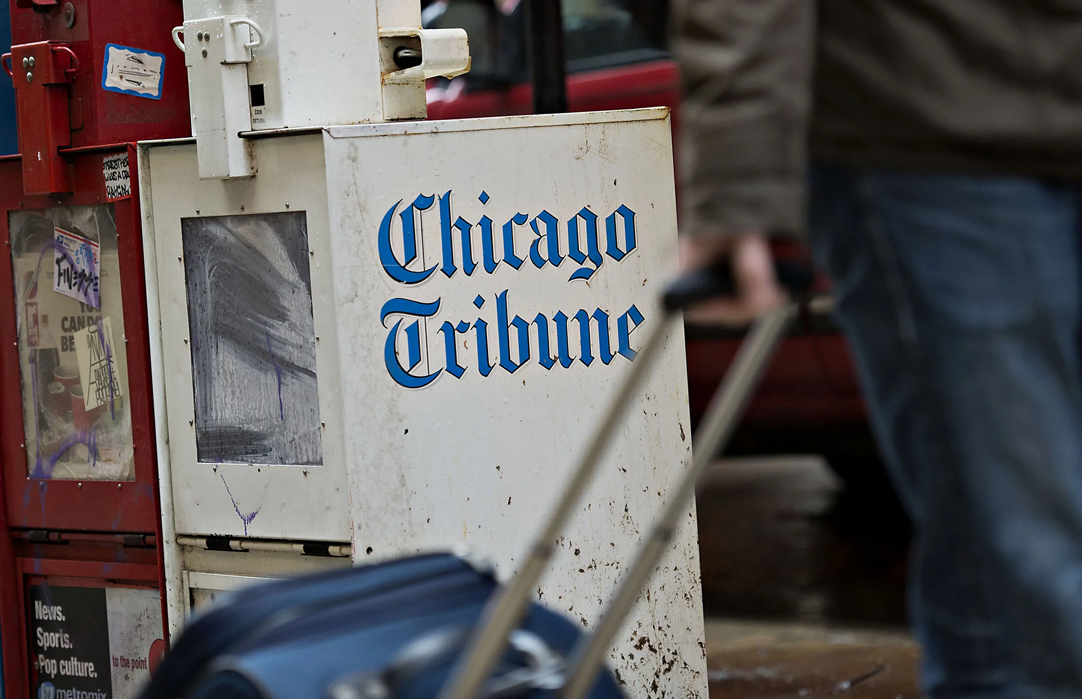 A pedestrian passes a Chicago Tribune honor box in Chicago.

