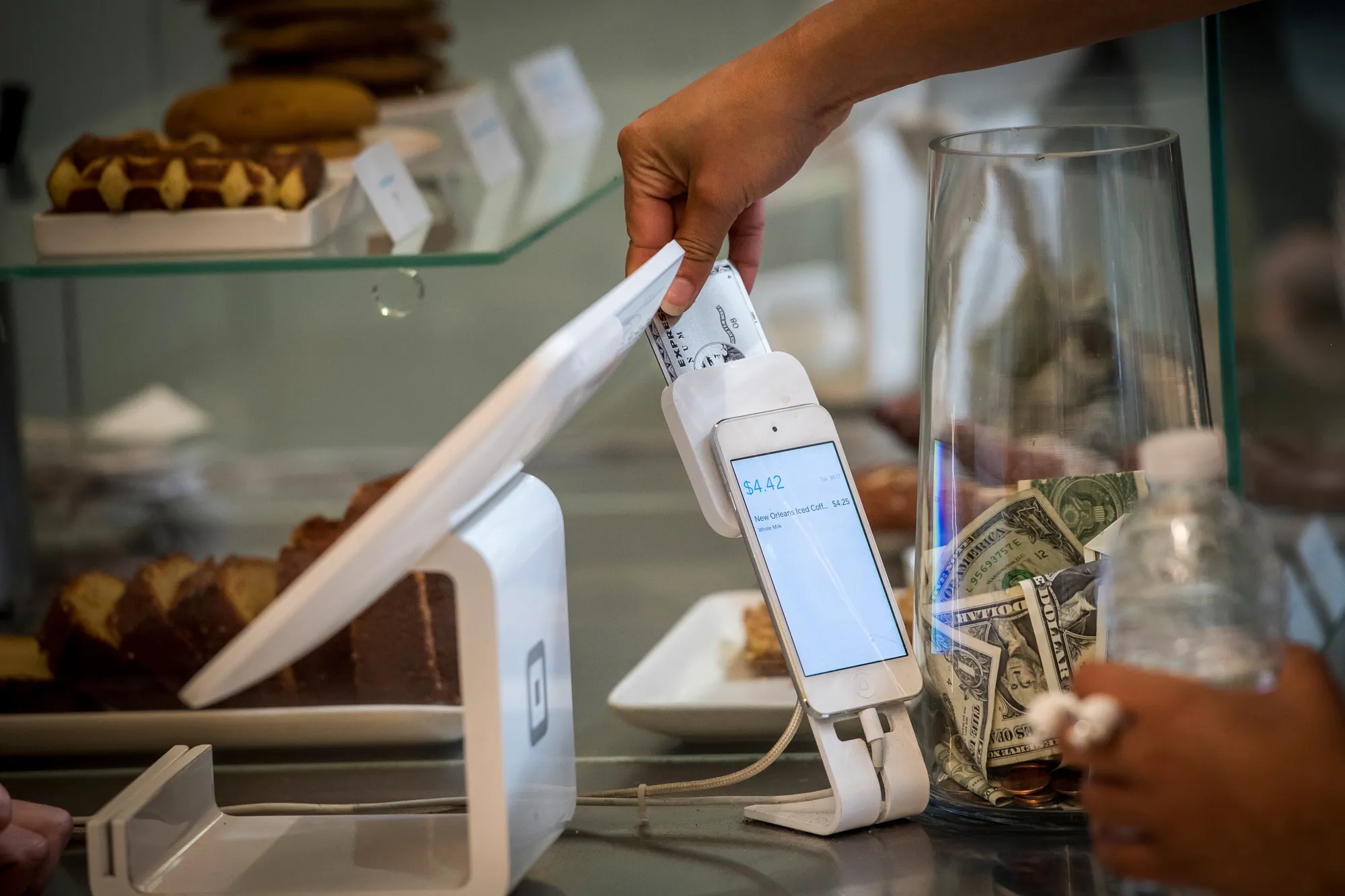 A customer inserts a credit card into Square Inc. device while making a payment in San Francisco, California, U.S.