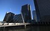 Pedestrians cross a foot bridge towards the offices of global financial institutions, including JPMorgan Chase & Co. and the commercial office block No. 1 Canada Square, in the Canary Wharf financial, shopping and business district in London, U.K., on Tuesday, April 18, 2017. Global banks have started arranging for some British-based operations to move to new or expanded offices inside the EU after British Prime Minister Theresa May triggered discussions to leave the trading bloc.