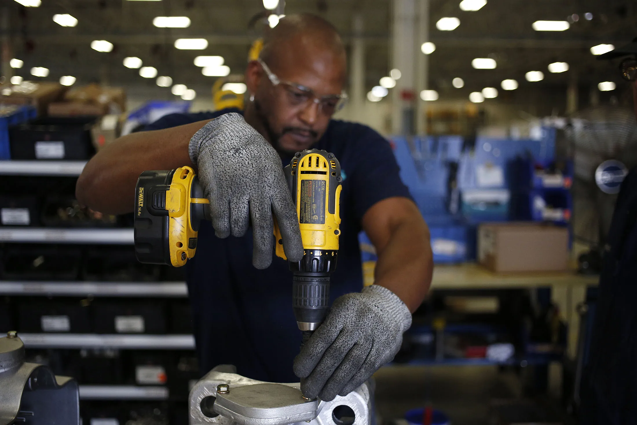 A worker uses a power drill while assembling a railroad crossing signal at the Siemens Rail Automation Corp. manufacturing facility in Louisville, Kentucky, on May 16, 2017.
