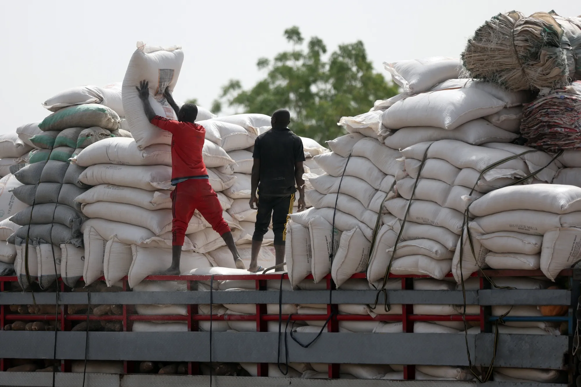Bags of maize are offloaded from a truck at a market in Jibia, Nigeria on Feb. 18.