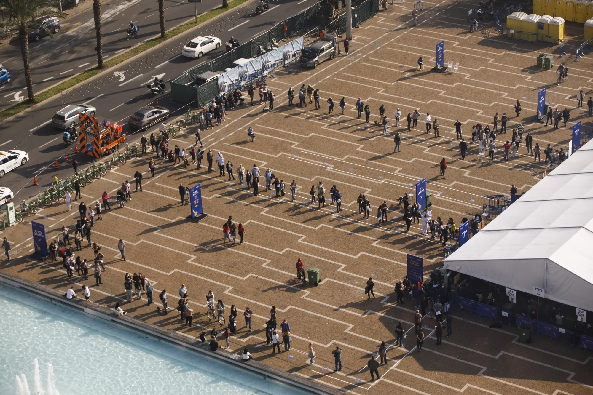 People queue outside a Covid-19 mass vaccination center at Rabin Square in Tel Aviv.