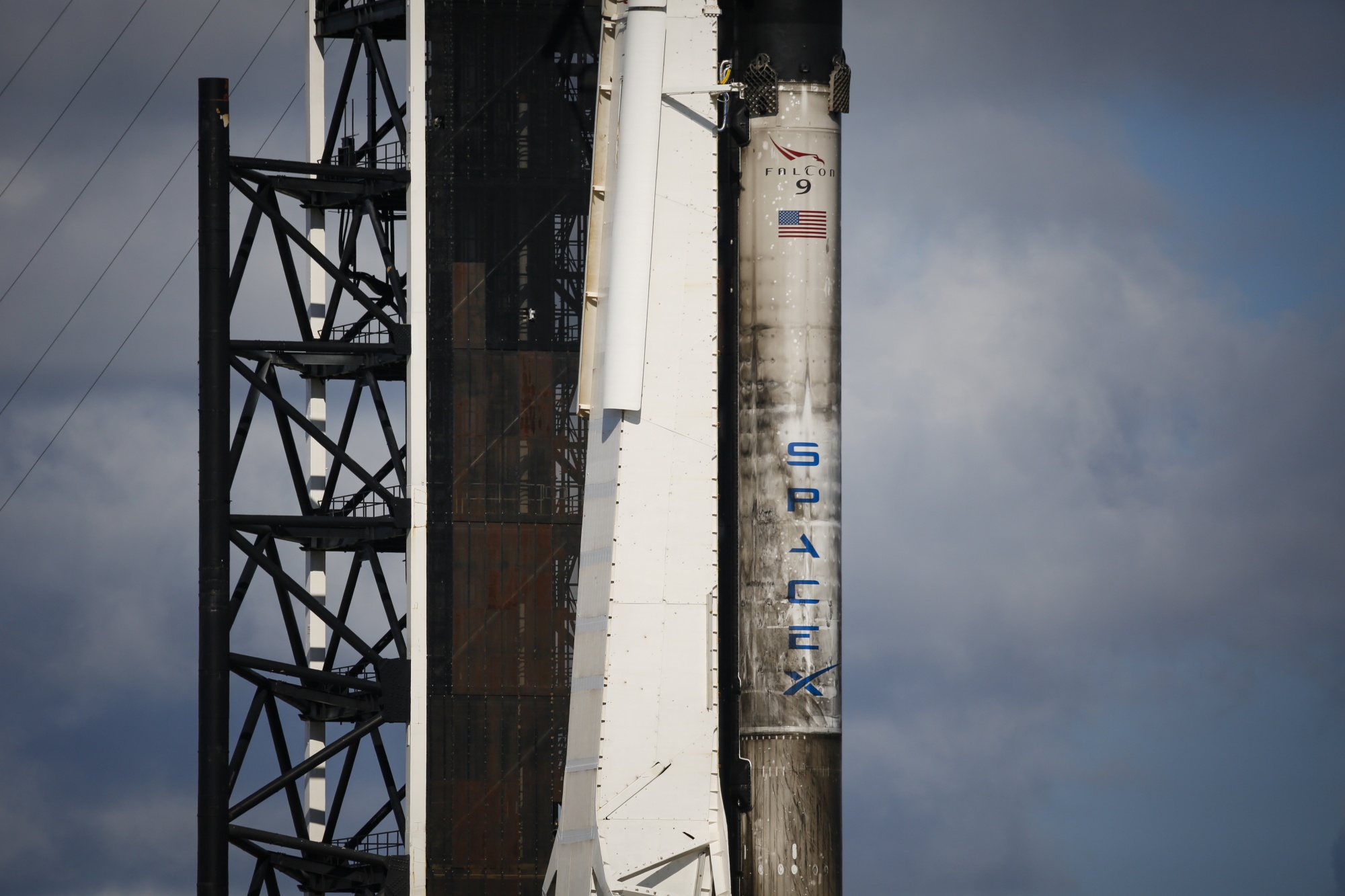 A close up photograph of the Falcon 9 rocket on its launchpad, stained with burn marks from previous launches