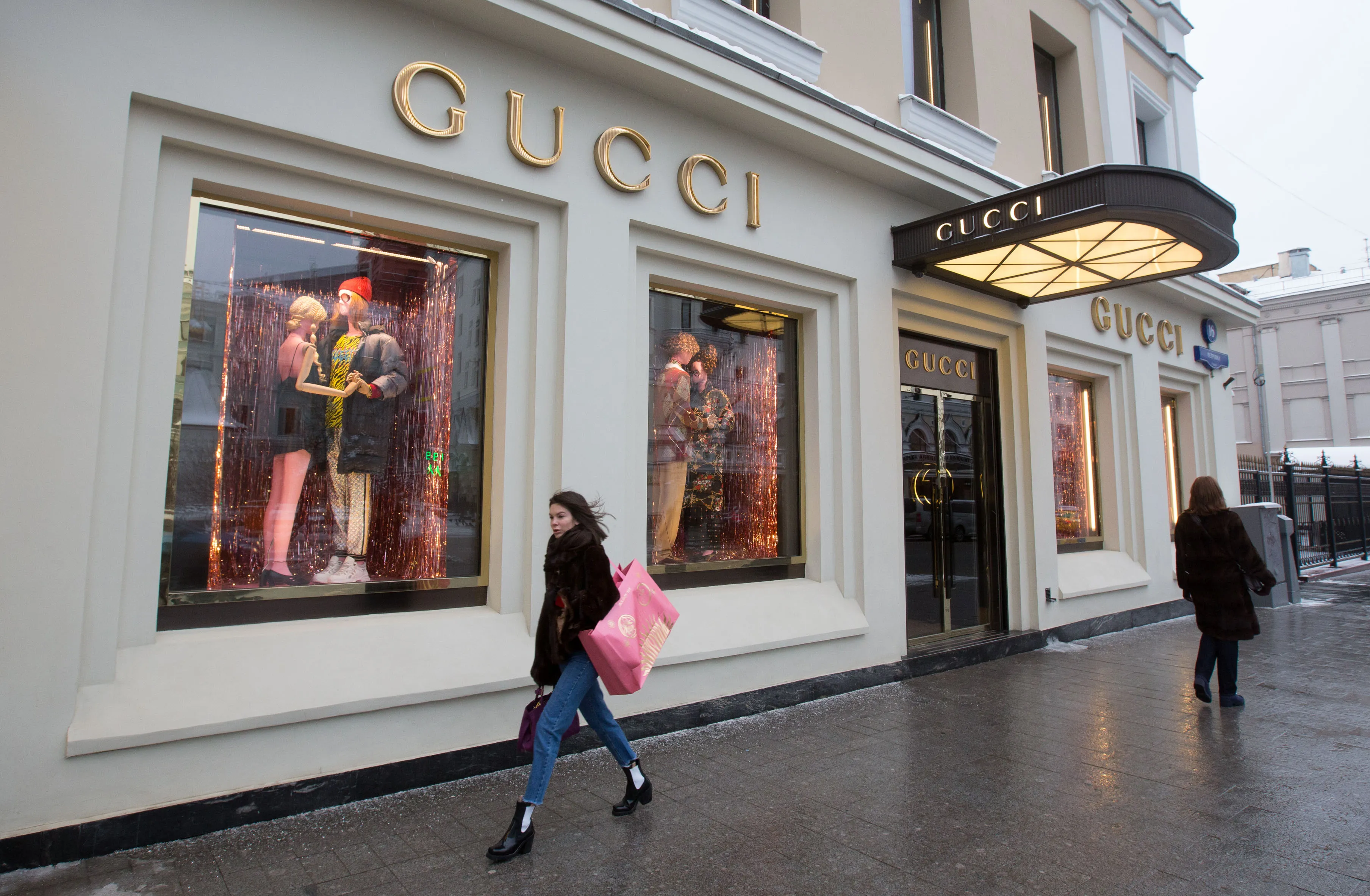 Pedestrians pass by a Guccio Gucci SpA store in Moscow, Russia.