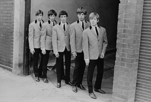 The Rolling Stones in matching jackets and Chelsea boots.