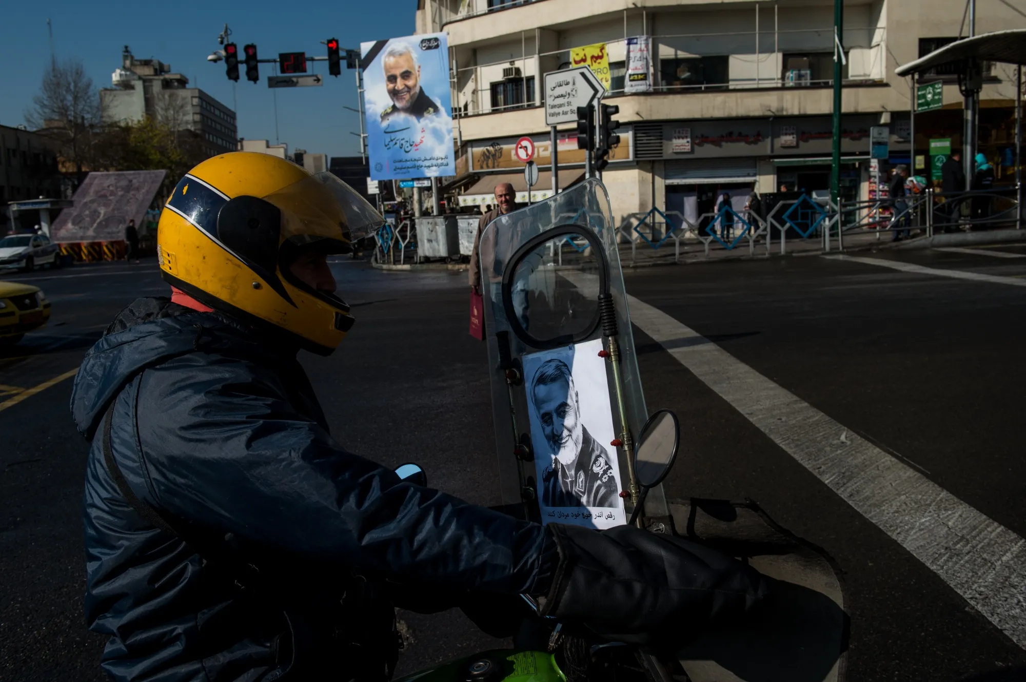 A motorcyclist rides with a portrait of&nbsp;Qassem Soleimani in Tehran on Jan. 5.