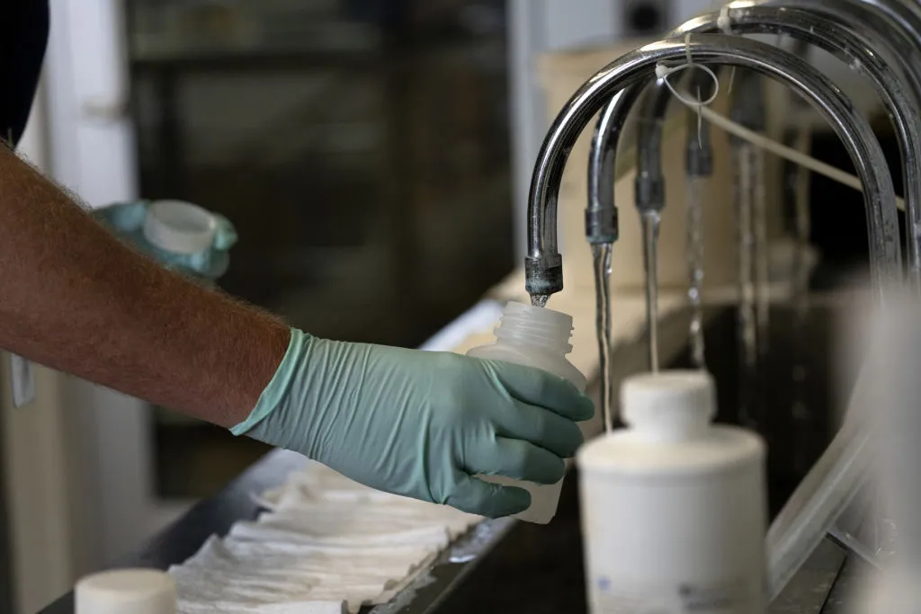 A geologist collects samples of treated Lake Michigan water in a laboratory at a water treatment plant in Wilmette, Illinois.