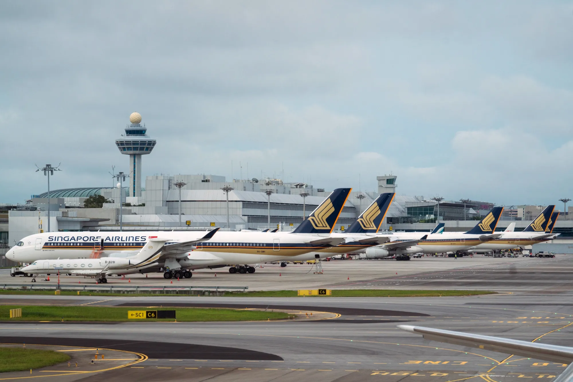 Singapore Airlines Ltd. aircraft stand on the tarmac at Changi Airport in Singapore.