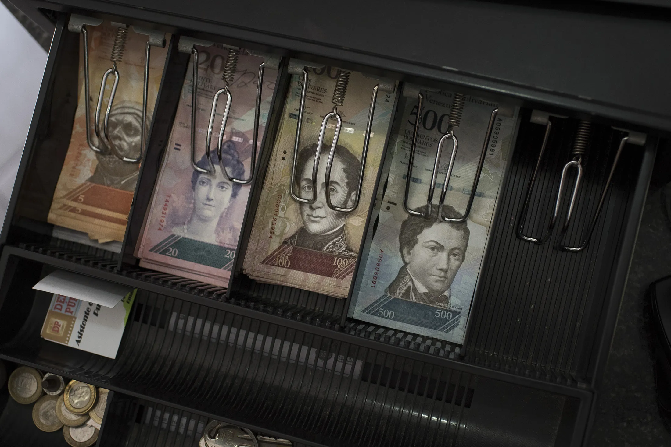Bolivar banknotes&nbsp;sit in a cash register in&nbsp;Venezuela