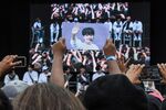 A fan holds up a photo of a Korean boyband star during 2018 KCon in New Jersey..