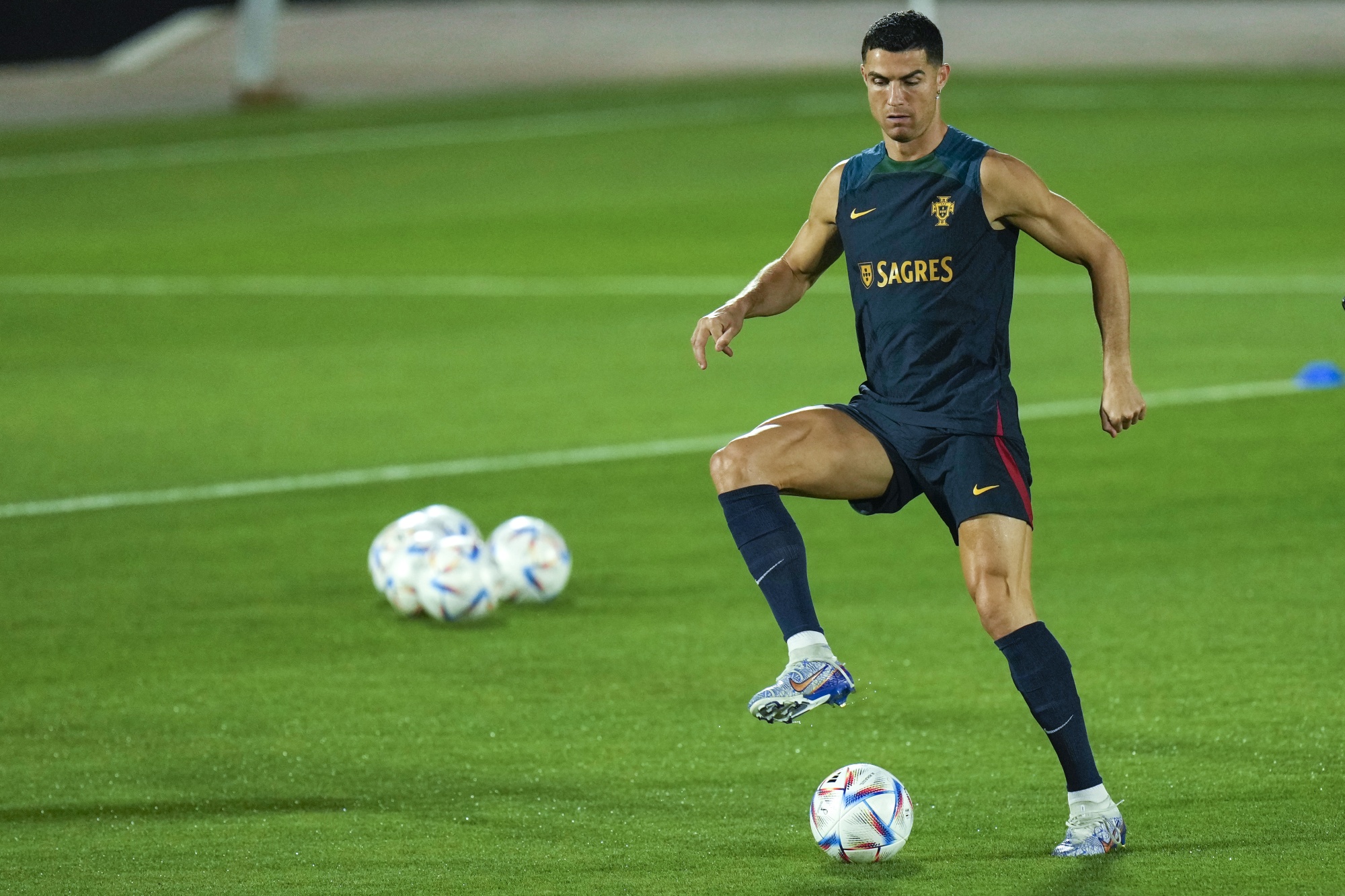 Portugal's Cristiano Ronaldo heads the ball during a team training