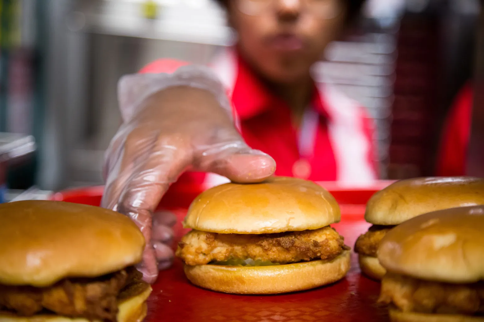 A employee picks up a fried chicken sandwiches at a Chick-fil-A restaurant in New York, U.S.