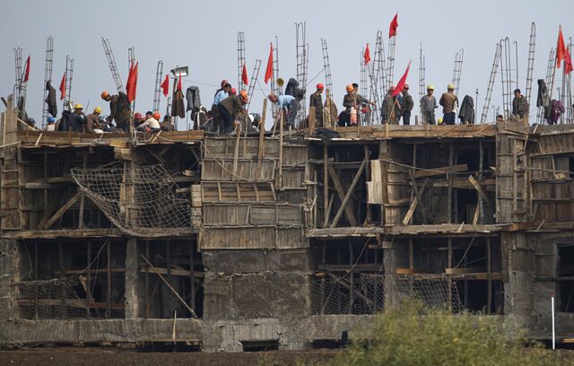 Construction workers at a site in North Korea near the border with China, in October 2024.