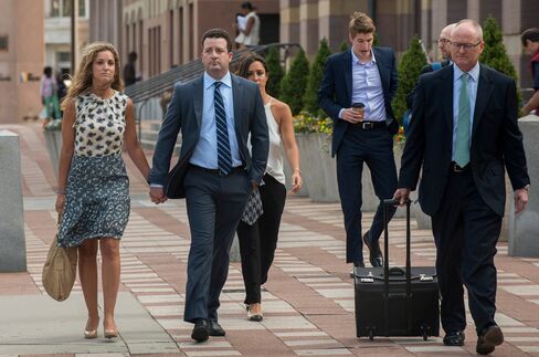 Jesse Litvak, a former managing director at Jefferies & Co., second left, arrives at federal court in New Haven, Conn., on July 23, 2014.