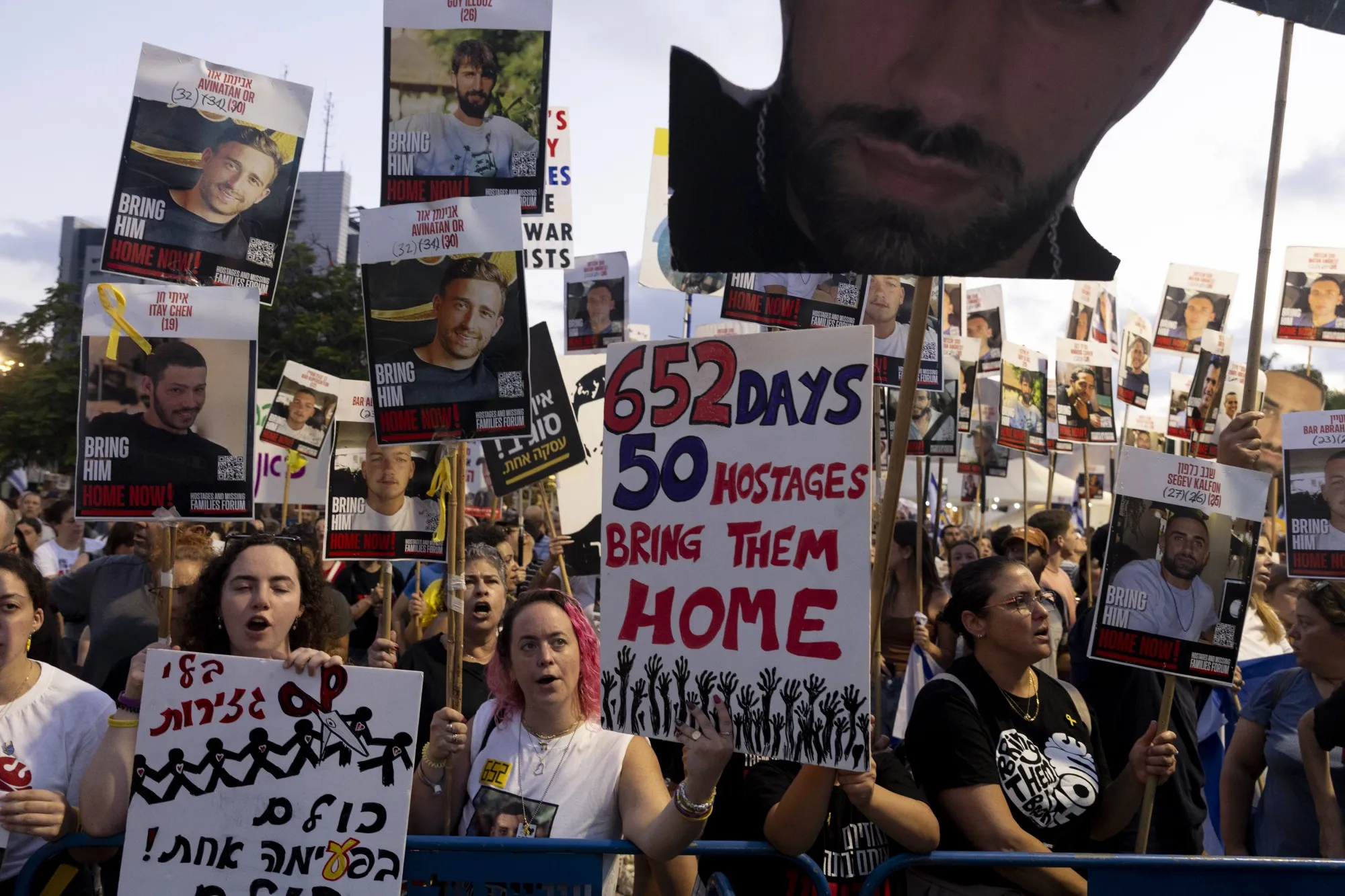Families of hostages and their&nbsp;supporters hold signs and photos during a rally&nbsp;on July 19, 2025 in Tel Aviv, Israel.