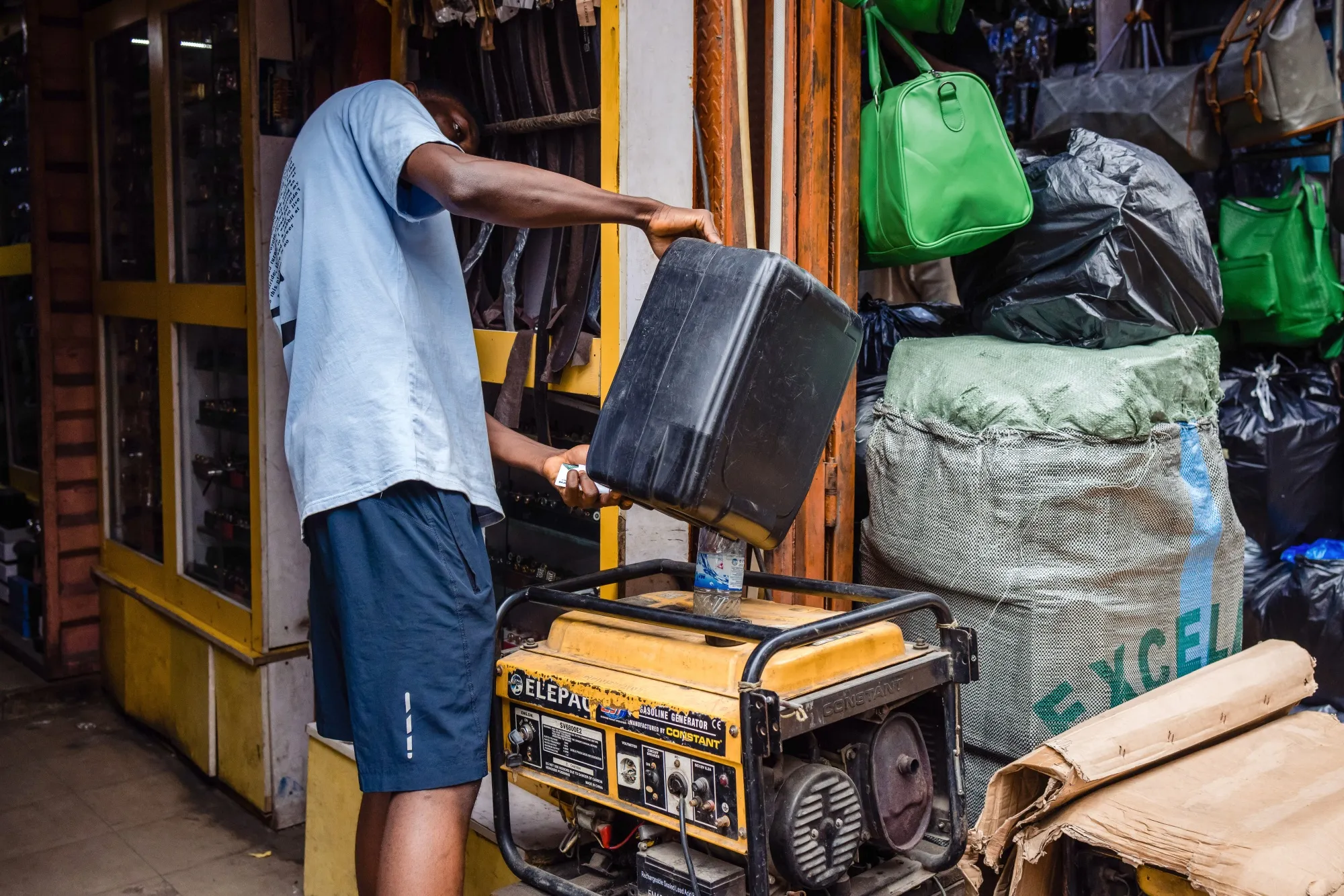 A trader pours fuel into a power generator at the Lagos-Island market in Lagos, Nigeria, on Wednesday, Aug. 23, 2023. 