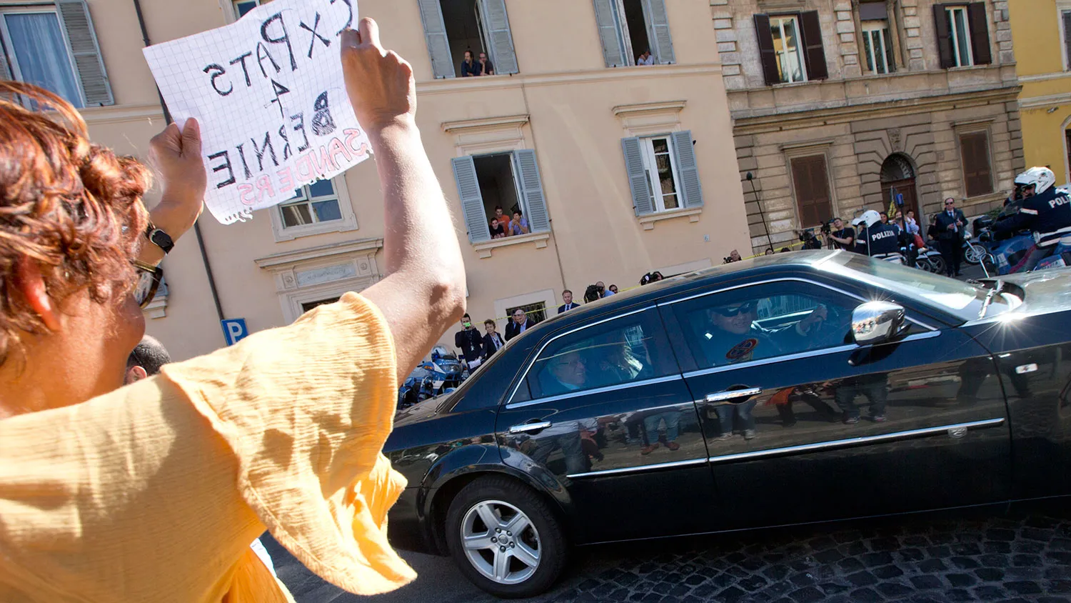 Democratic presidential candidate Bernie Sanders, sitting in the back of the car, is welcomed by supporters upon his arrival at the Vatican to attend a conference on April 15, 2016.
