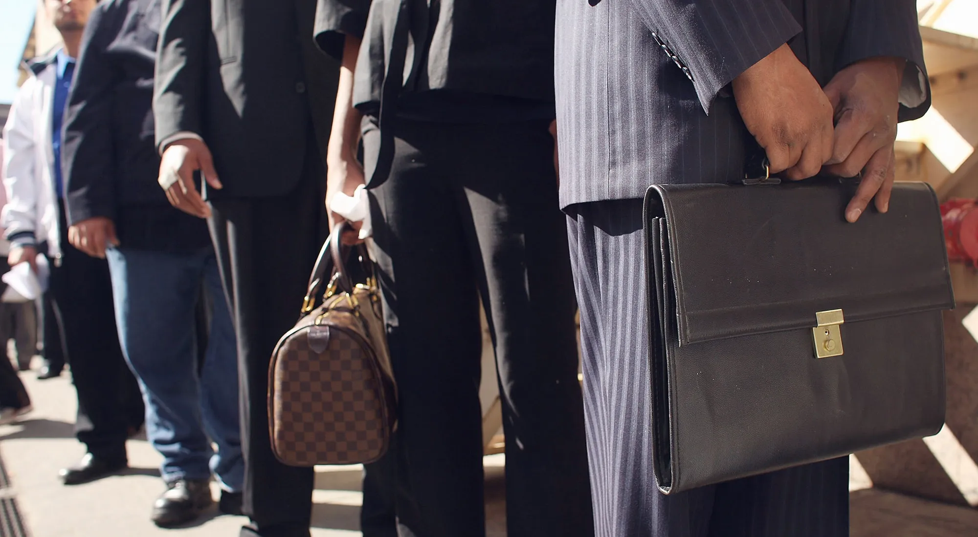 People wait in line to get into a job fair in New York.