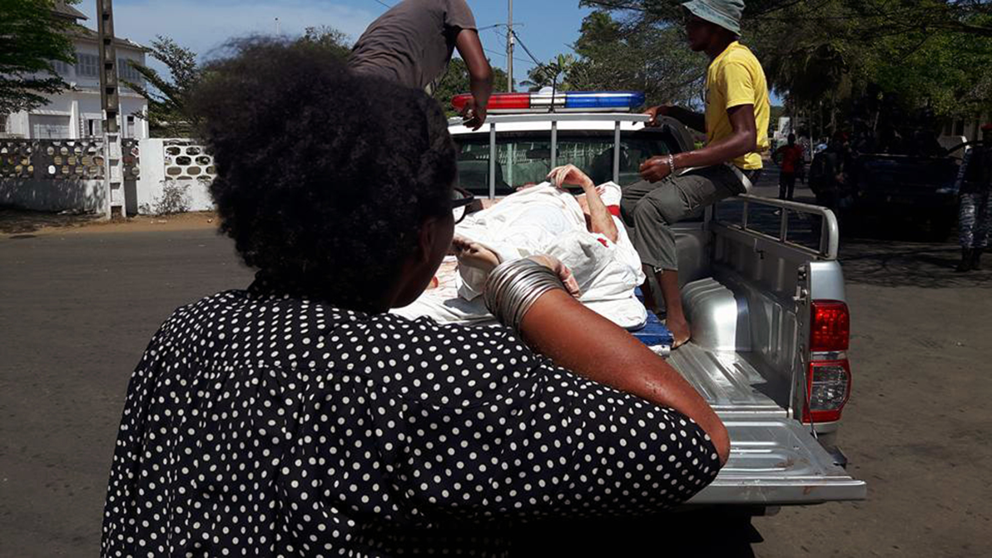 A photo taken by a witness at the scene shows the victims of a fusillade being loaded on a pick-up truck in front of a hotel in Grand-Bassam, on March 13, 2016 after heavily armed gunmen opened fire.
