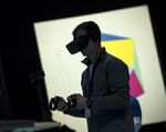 An attendee uses an Oculus VR Inc. Virtual Reality headset during the F8 Developer Conference in San Jose, California, U.S.