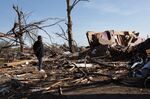 A man looks at the remains of his home after an EF-4 tornado touched down on March 26 in Rolling Fork, Mississippi.