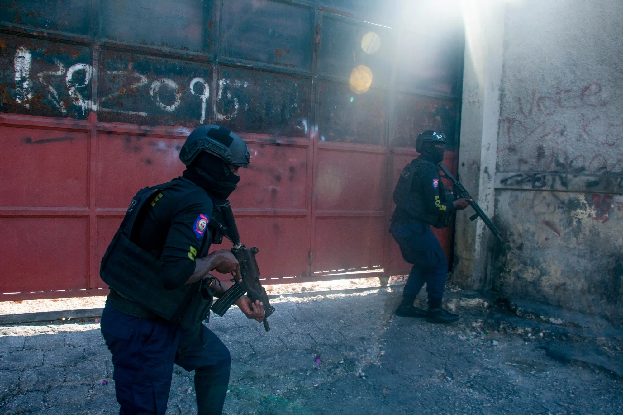 Armed police officers monitor a street after gang violence in Port-au-Prince, Haiti, on March 22.