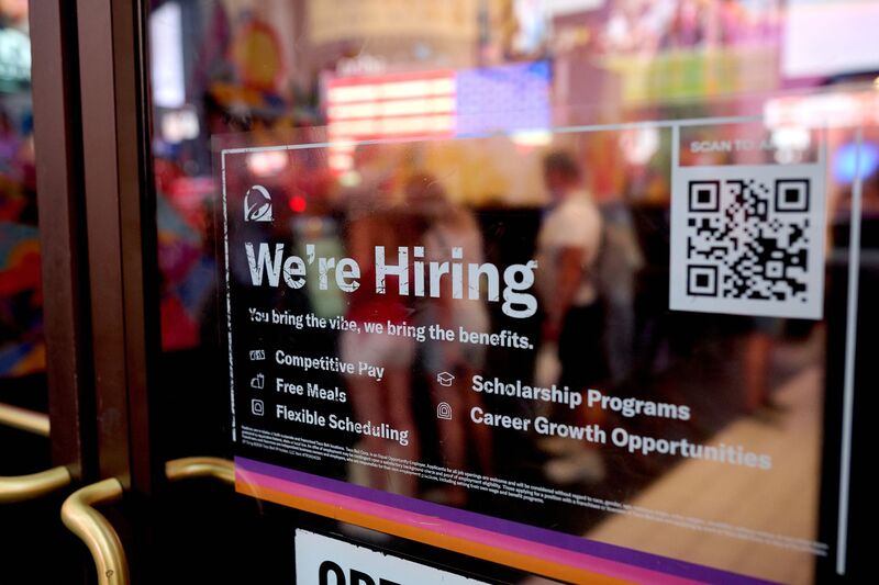 A "We're Hiring" sign displayed at a Taco Bell restaurant in New York, US. 