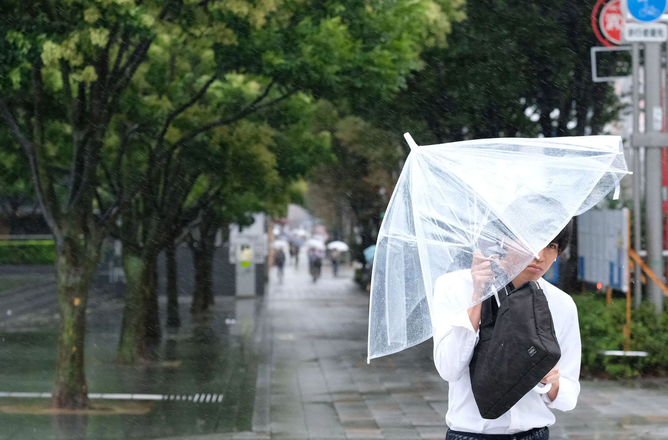 A pedestrian walks in the rain in Tokyo on Aug.&nbsp;8.