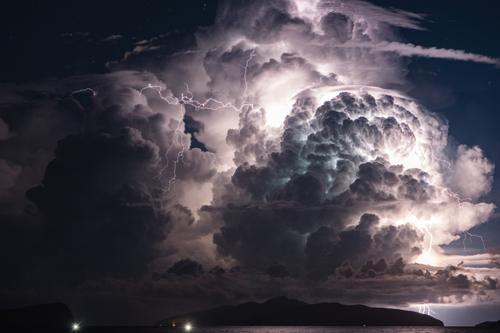 Dramatic cloud and thunderstorm over an island. Multiple Lightni