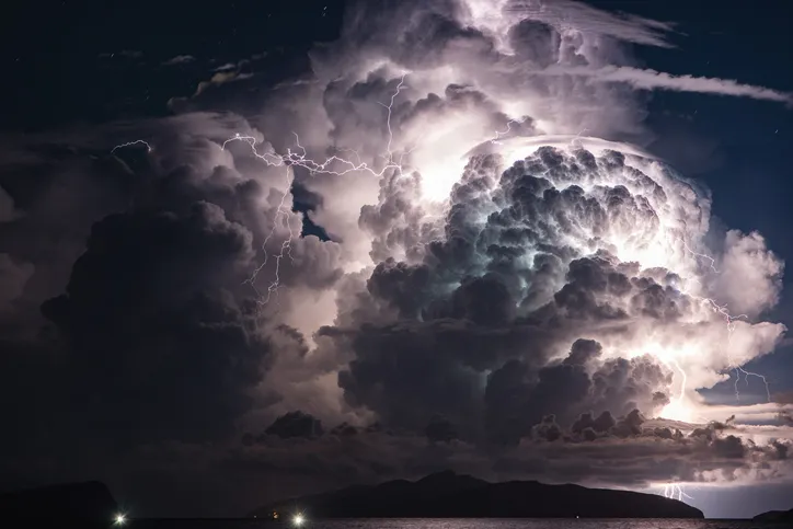 Dramatic cloud and thunderstorm over an island. Multiple Lightni