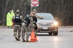 Members of the military police set up cones at a checkpoint at the first rest stop after leaving Connecticut on I-95 on March 29.