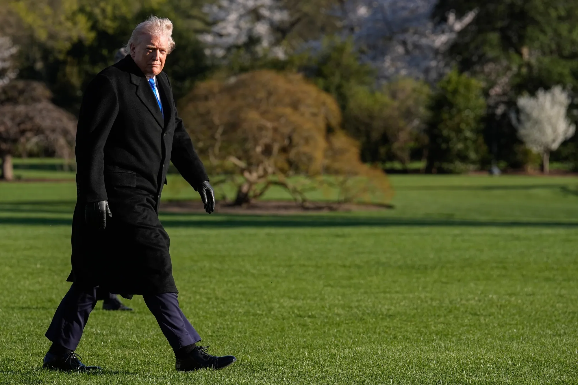 US President Donald Trump walks on the South Lawn of the White House after arriving on Marine One in Washington, on Monday, March 23, 2026.