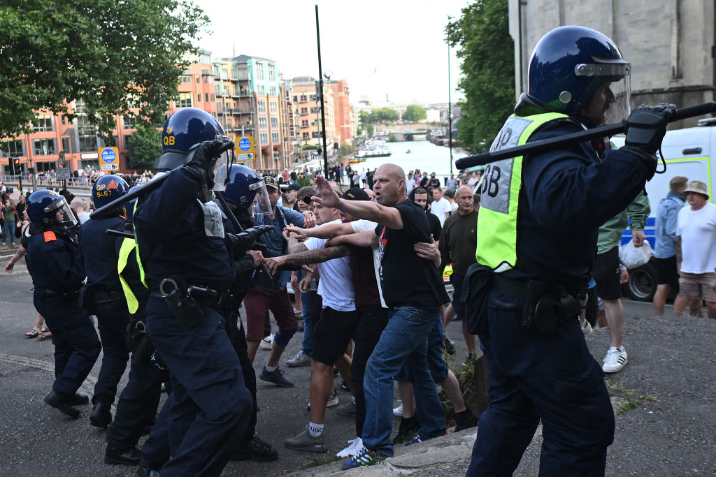 Police officers face off with protesters in Bristol, on Aug. 3