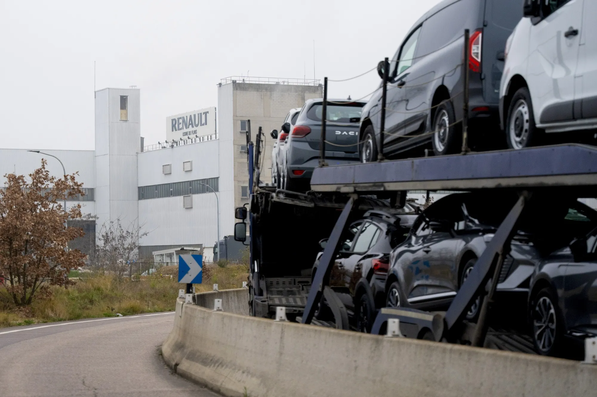 Newly manufactured vehicles on a transporter depart the Renault SA factory in Flins, France.