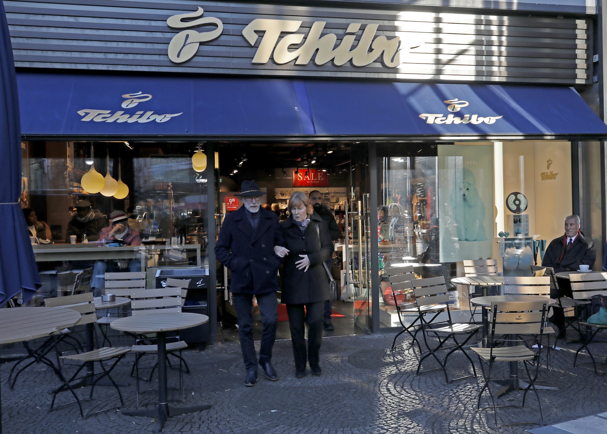 Pedestrians pass by a Tchibo coffee shop&nbsp;in Berlin.