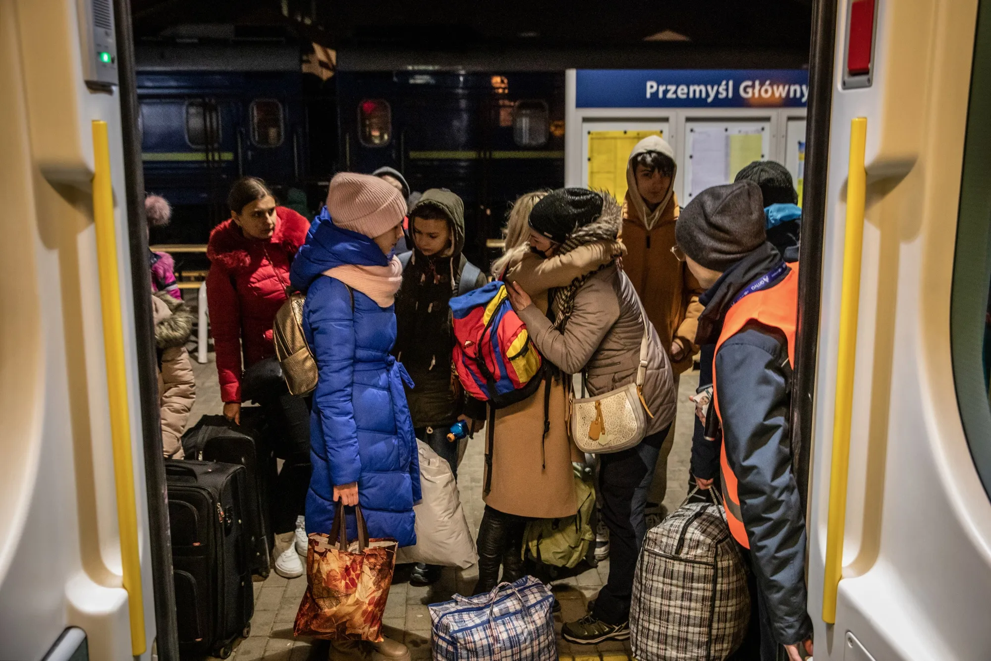 Ukrainian refugees embrace before boarding a train at Przemysl railway station, in Przemysl, Poland.