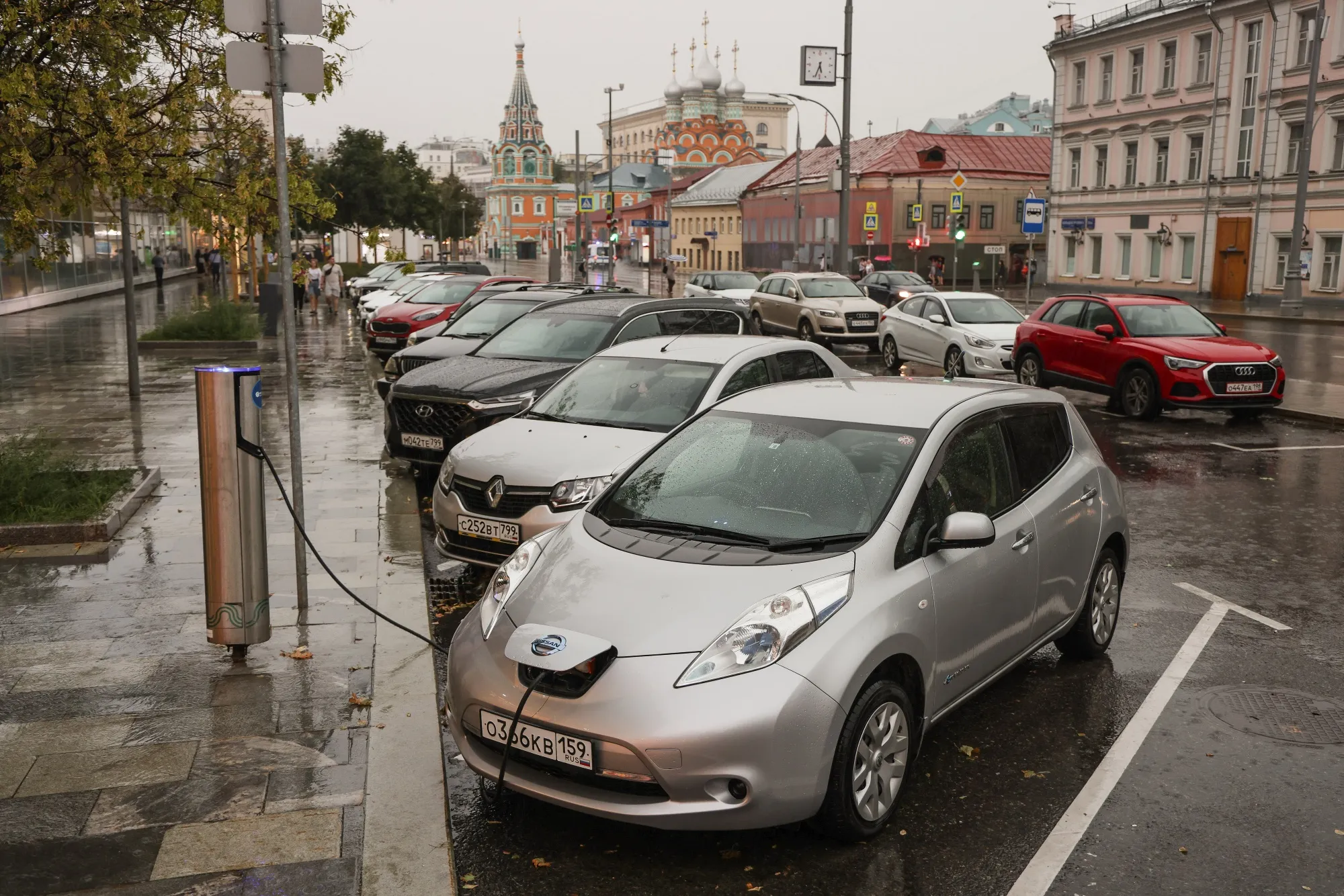 An electric automobile charges at a vehicle charging point in Moscow.