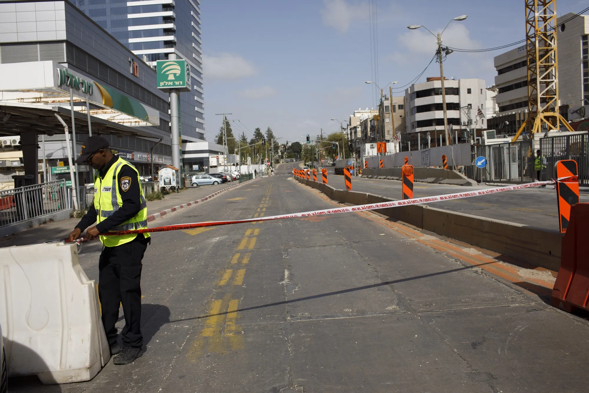 An Israeli police officer cordons off a highway to limit entry and exit during lockdown in the city of Bnei Brak, Israel, on April 6.