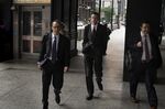 Michael Nowak, center, arrives at federal court in Chicago on July 8.