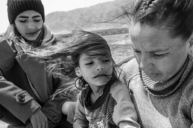 A mother and her two children ride on top of La Bestia, heading towards Ciudad Juarez, Mexico, on April 4, 2023.