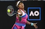 Naomi Osaka of Japan plays a forehand return to Madison Brengle of the U.S. during their second round match at the Australian Open tennis championships in Melbourne, Australia, Wednesday, Jan. 19, 2022. (AP Photo/Andy Brownbill)