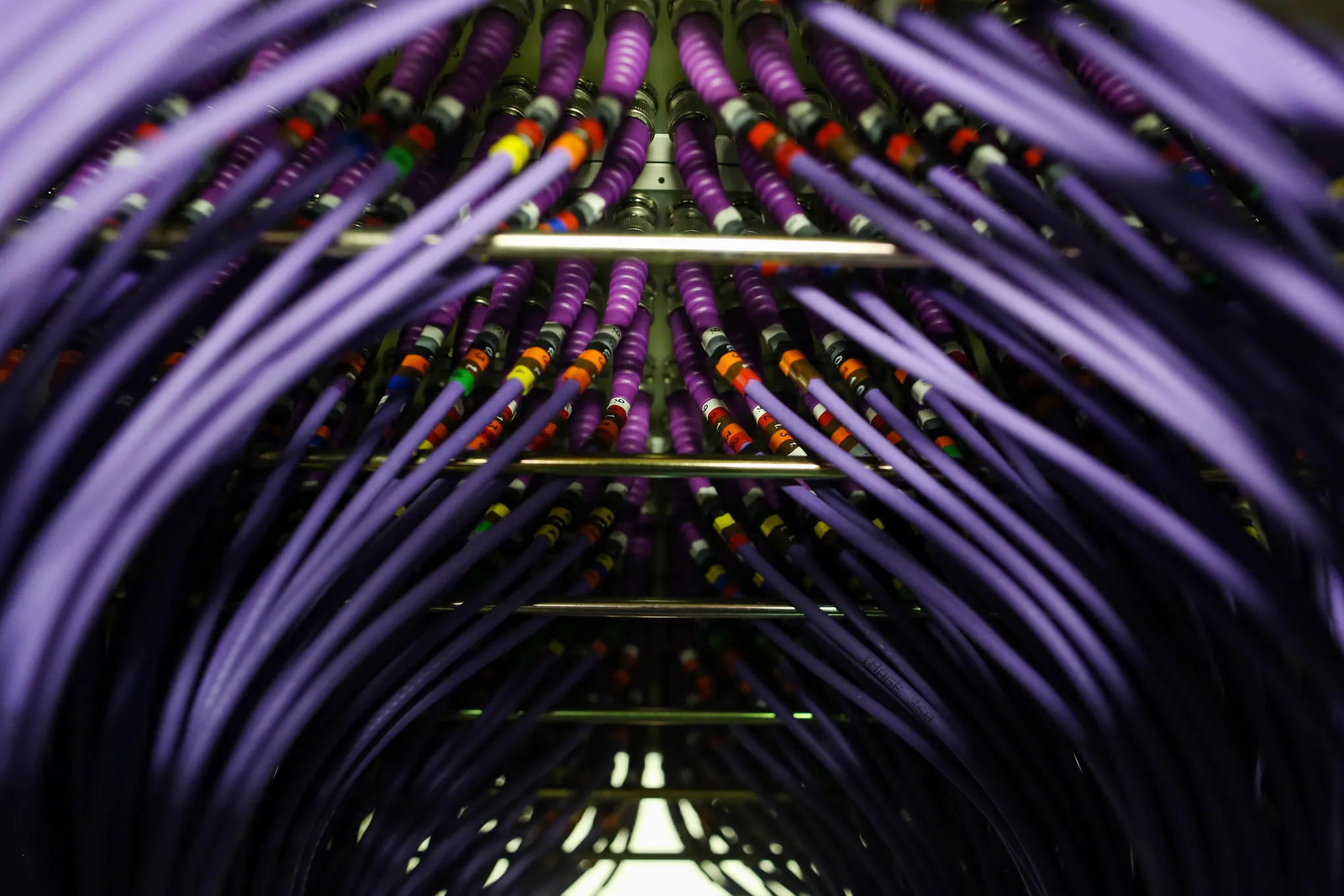 Coaxial cables feed into a server inside a comms room at an office in London, U.K., on Friday, Oct. 16, 2015. A group of Russian hackers infiltrated the servers of Dow Jones & Co., owner of the Wall Street Journal and several other news publications, and stole information to trade on before it became public, according to four people familiar with the matter.