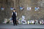 A Police officer at the scene of last night's attack near Finsbury Park mosque.