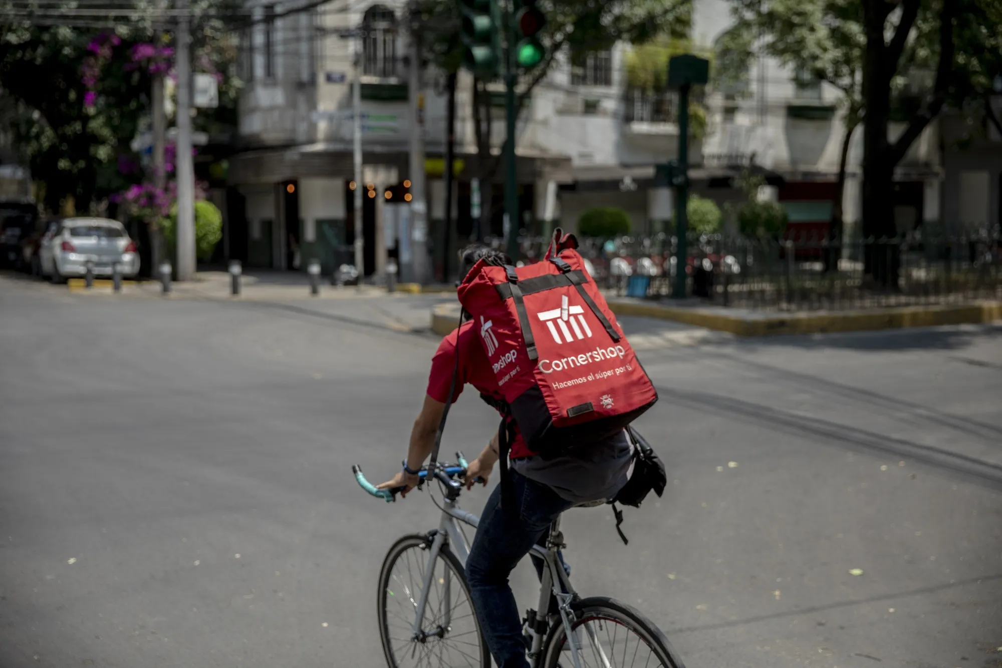 A worker rides a bicycle while making a Cornershop app delivery in Mexico City, Mexico.