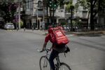 A worker rides a bicycle while making a Cornershop app delivery in Mexico City, Mexico.