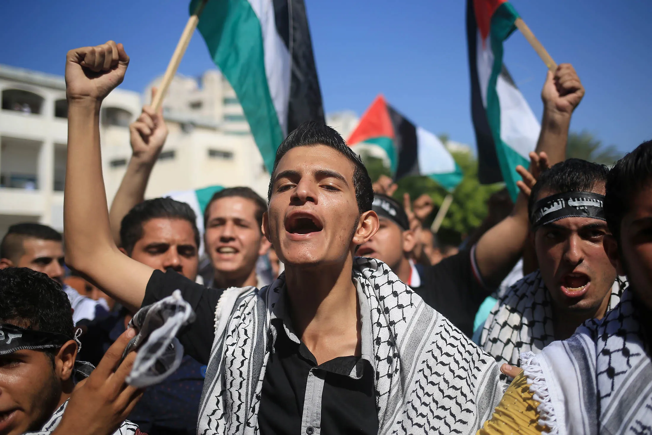 Palestinian university students shout slogans during a rally in Gaza City.
