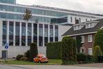 A building at the ASML Holding NV global headquarters towers over nearby housing in Veldhoven, Netherlands, on Oct. 14.