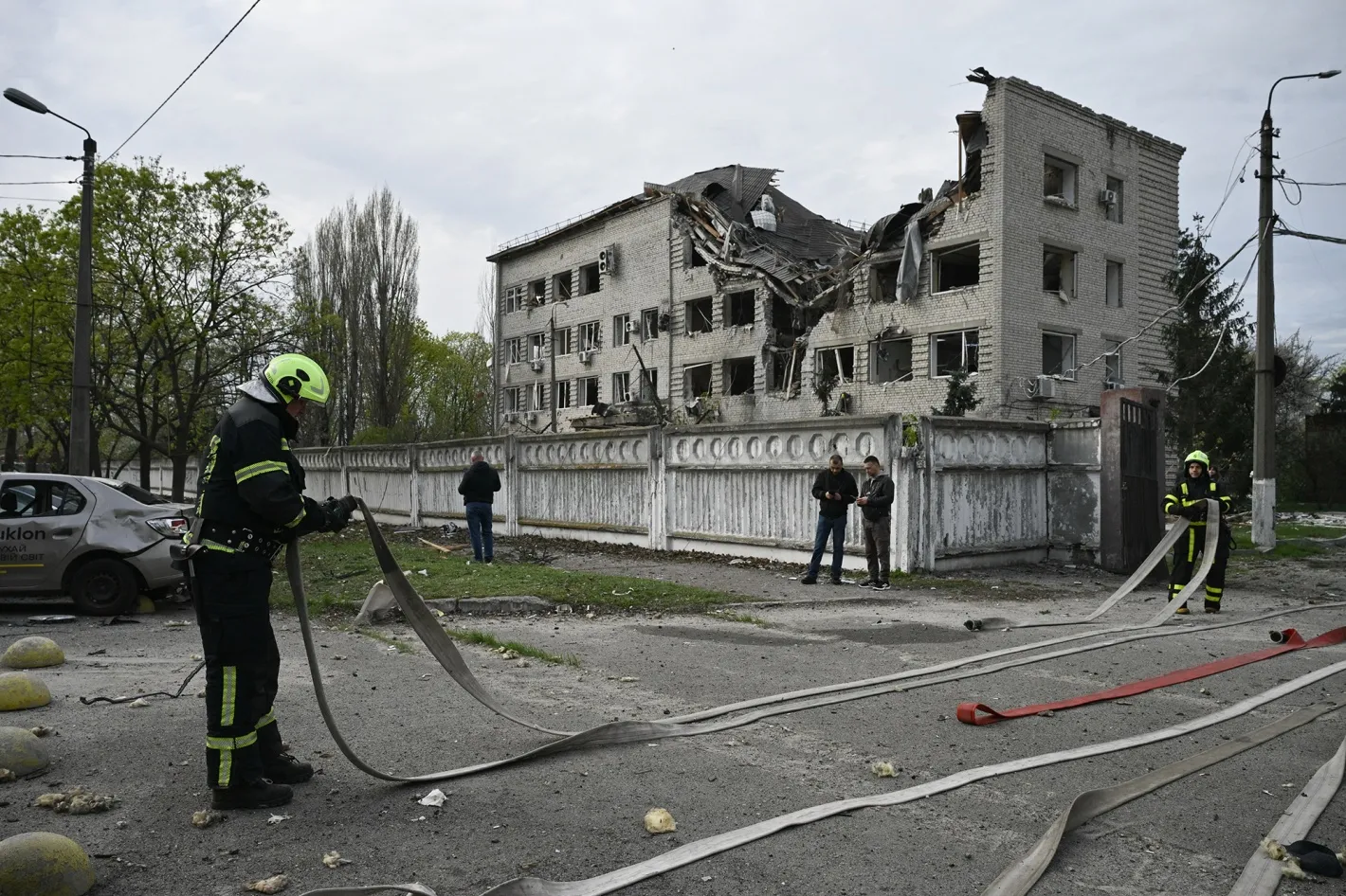 Firefighters work at a site following a Russian strike in Kyiv on April 16.