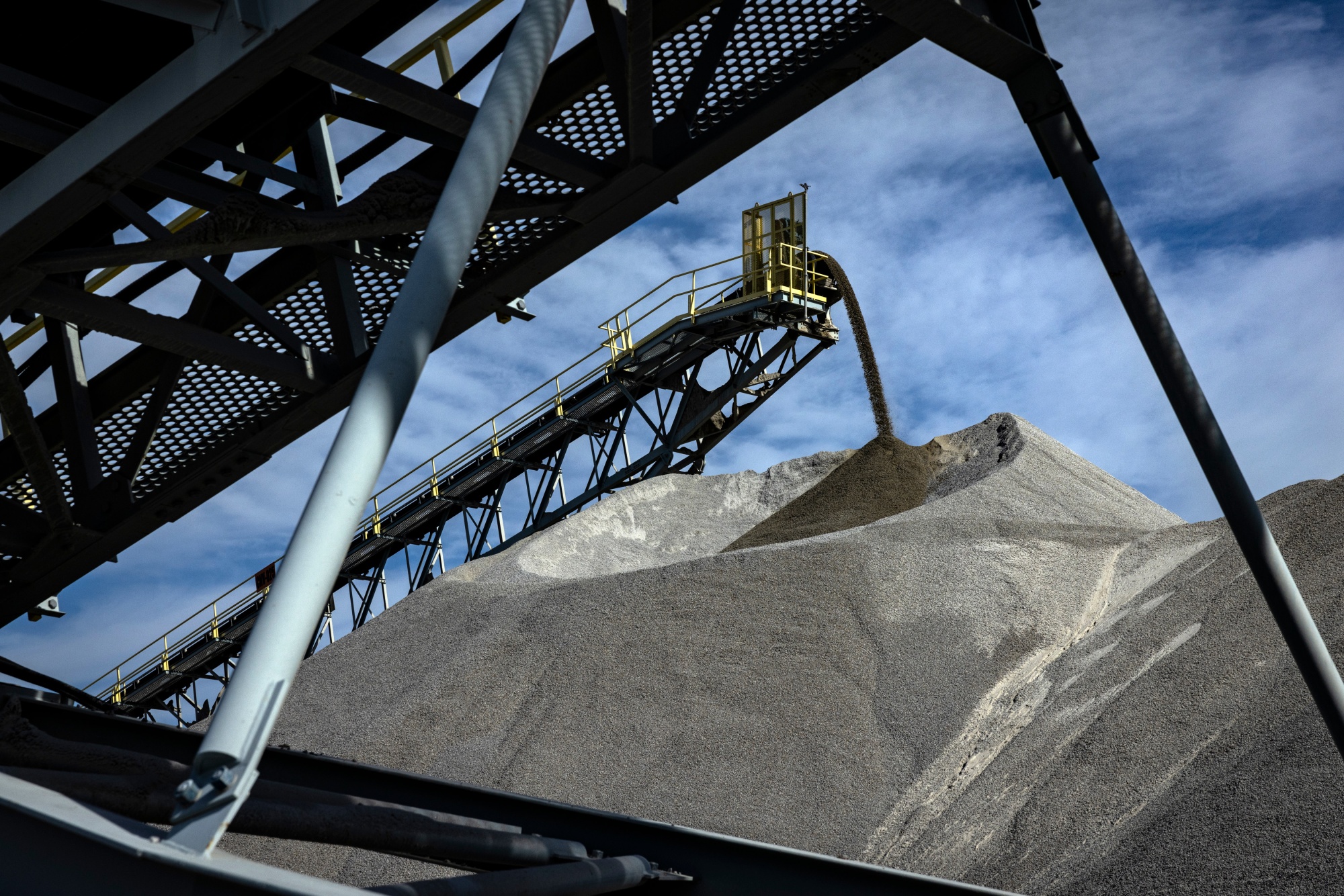 Conveyor belts move crushed material into piles in the storage area at a Vulcan Materials Company Graham quarry.