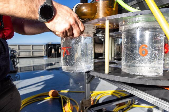 Tommy Knowles puts collection canisters back onto the MiniROV after the expedition.